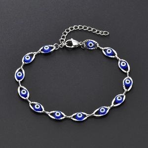 Close-up of blue resin evil eye charms and silver stainless steel chain with lobster clasp