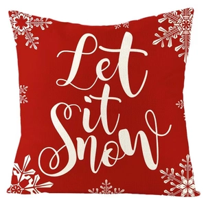 Detail of red Christmas pillowcase featuring white Let it snow text and snowflake patterns