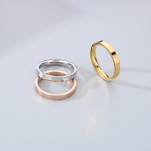 Three minimalist 3mm stainless steel rings in silver, rose gold, and gold metallic finishes