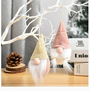 Detail of Christmas gnomes with gold and pink hats and soft white beards for tree decor