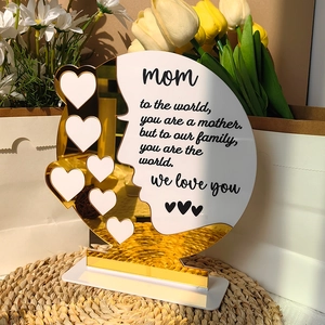 Detail showing acrylic Mother's Day plaque with golden hearts and sentimental quote