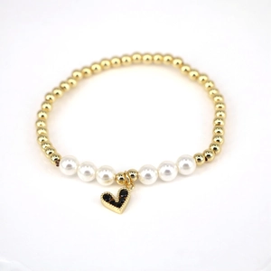 Detail of beaded bracelet with gold spheres, pearls, and a black zircon heart charm
