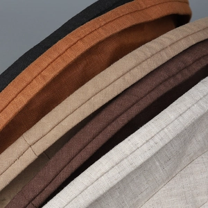 Detailed macro shot of textured linen fabric and stitching on multi-color bucket hats