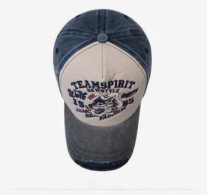Top view of vintage washed baseball cap with wolf head embroidery and worn brim detail