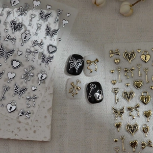 Detailed 3D metallic butterfly and heart nail art stickers in gold and silver finish