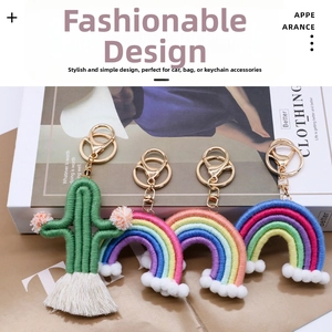 Detail of handmade woven rainbow and cactus keychains with tassels on a book background