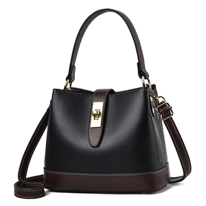 Classic black and brown bucket handbag with gold metal lock and contrast stitching