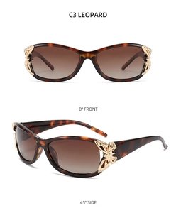 Detail of leopard print sunglasses featuring golden metal butterfly accents and tea lenses