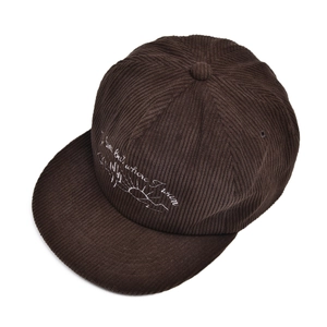 Detail showing the cactus embroidery and corduroy texture of the dark brown baseball cap