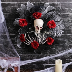 Halloween wreath with red roses, white skull, black crow, and mesh ribbon on a wall
