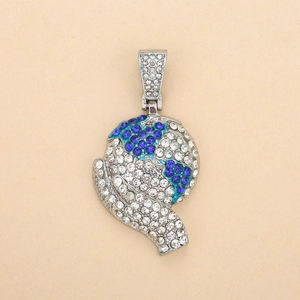 Macro shot of silver-tone iced out world map pendant with blue and white rhinestones