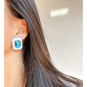 Elegant white enamel rectangular earrings with blue square zircon on model