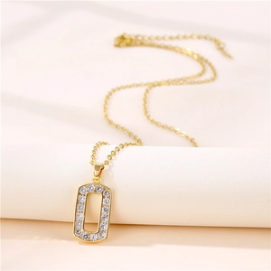 Hip hop gold necklace with rectangular white zircon letter O pendant on white fabric