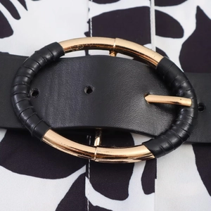 Chic poplin dress with floral print and black leather belt featuring a gold oval buckle