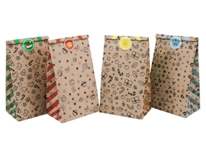Detail view of four Christmas kraft paper gift bags with festive patterns and stickers