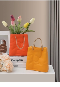 Macro detail of creative paper bag ceramic vase with rope handle and tulip flowers