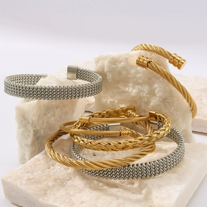 Twisted steel cable bangle in gold and silver finish with woven metal texture