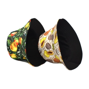 Double-sided bucket hat featuring tropical avocado and fruit prints for outdoor sun protection