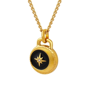 Gold starburst pendant necklace with black enamel center and sparkling zircon detail