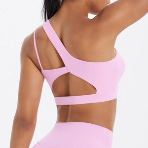 Detailed back view of pink one-shoulder sports bra featuring geometric hollow out design