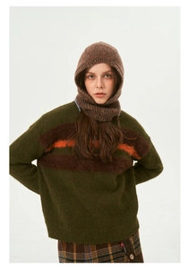 Close-up of dark green knit sweater with brown fuzzy stripes and matching balaclava hood