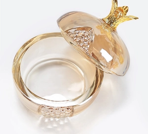 Detailed view of amber glass pomegranate nail art cleaning jar with gold metal lid stem
