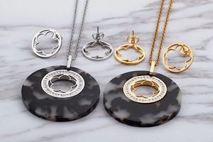 Detail of vintage gold and silver pendant necklaces with resin tortoise patterns and crystals