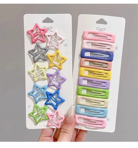 Detail of colorful star and rectangular metal hair clips set in candy macaron colors