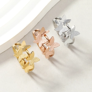 Close-up of frosted and polished butterfly rings in gold, rose gold and silver finishes