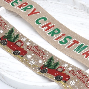 Close-up of linen Christmas ribbon with red trucks and Merry Christmas text print