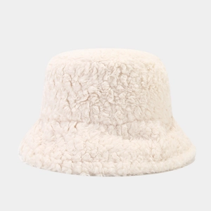 Close-up of white plush bucket hat showing the soft lamb wool texture for winter warmth