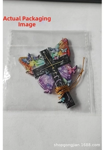 Flat lay of butterfly cross acrylic ornament with golden wire cord in transparent packaging