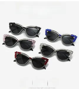Detail of five cat-eye sunglasses with rhinestone-encrusted frames and colorful crystals