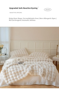 Detail of cream rabbit fur textured blanket showing reactive dyeing and soft fabric