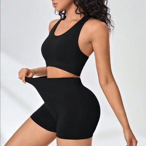 Seamless high-stretch black yoga set including sports bra and high-waist shorts for fitness