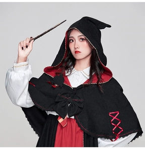 Close-up of wizard costume set with hooded cloak, shirt and magic wand prop for cosplay