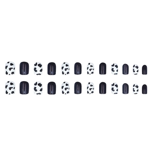 Short square press-on nails with minimalist black and white cow print patterns