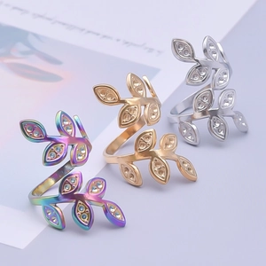 Detail of adjustable stainless steel leaf rings in iridescent, gold, and silver finishes