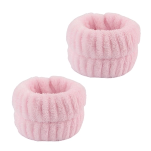 Close-up of pink coral fleece face washing wristbands with soft ribbed texture