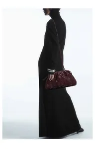 Close-up of deep red pleated woven leather bag with intricate Intrecciato craftsmanship