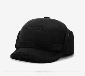 Close-up of black winter trapper hat with fleece lining and silver sports emblem