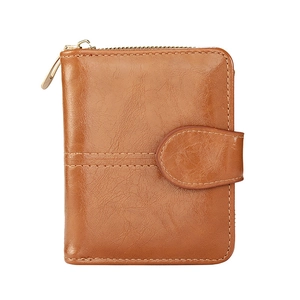 Brown leather short bifold wallet with vintage gold zipper and buckle on white background