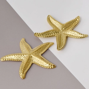 Macro detail of golden starfish pendants in 304 stainless steel for DIY jewelry making