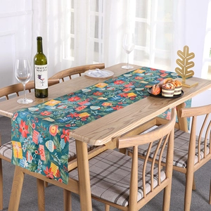 Christmas table runner with dark green background and festive red flower floral prints