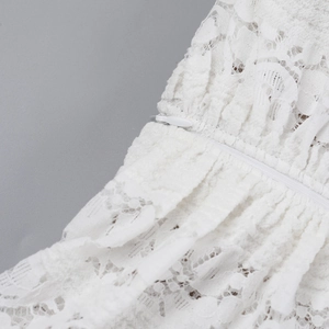 Close-up of white floral lace fabric texture and discreet invisible zipper detail