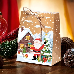 Close-up of kraft paper gingerbread house gift box with Santa Claus and twine rope