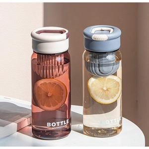 Close-up of portable plastic tea bottles with filter and fruit slices in pastel colors