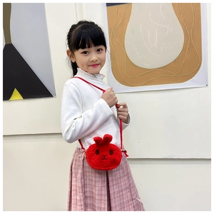 Detail of red plush bunny crossbody bag with soft faux fur texture and long ears for girls