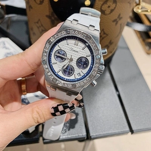 Detail of a luxury white silicone strap watch with a diamond-set octagonal silver bezel