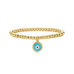Macro shot of gold-plated beaded bracelet with light blue enamel Evil Eye charm detail